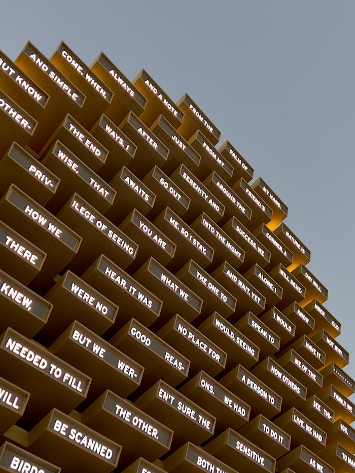 Words Written on Metal Slats on the Building Facade